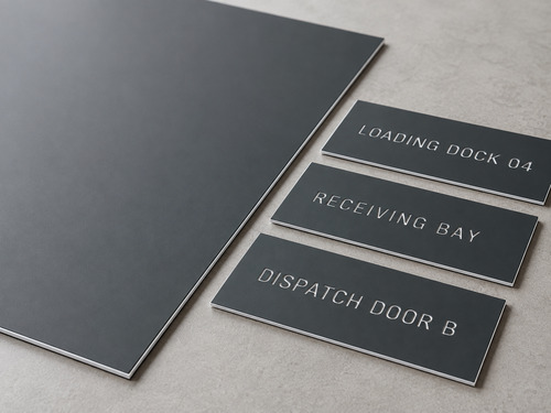 Loading Dock and Receiving Bay Sign Material LYS-7020 with thin matte charcoal face continuous white core and slightly recessed white wording